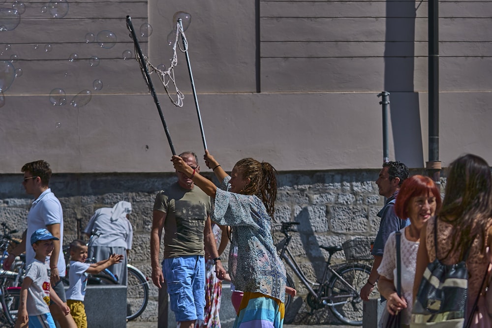 a group of people standing around a person shooting a bow and arrow