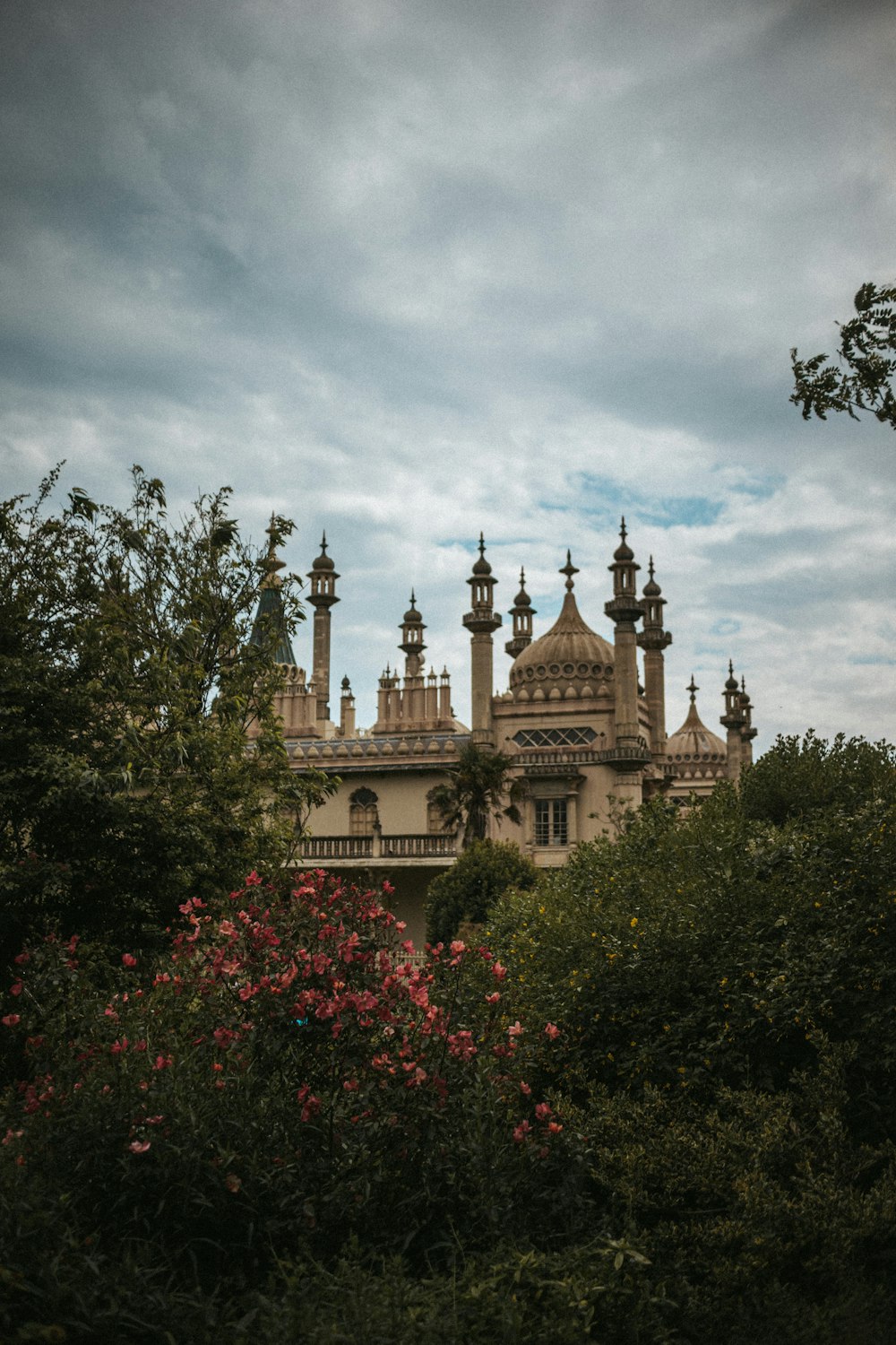 a large building with towers and spires surrounded by trees