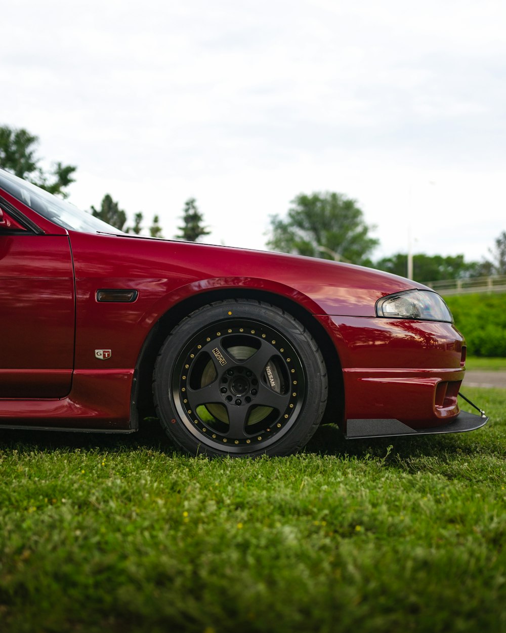 a red car parked on grass