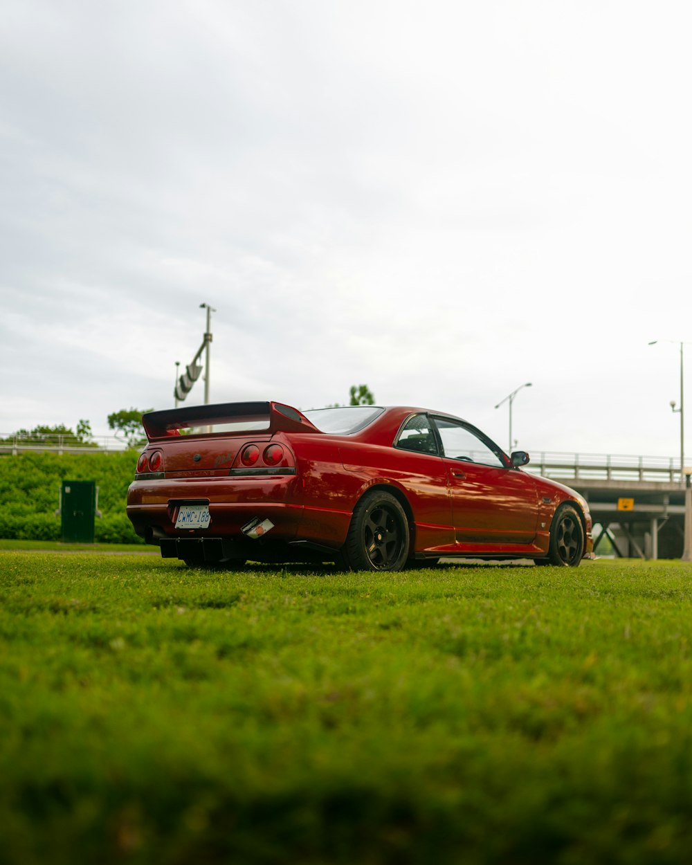 a red sports car parked on grass