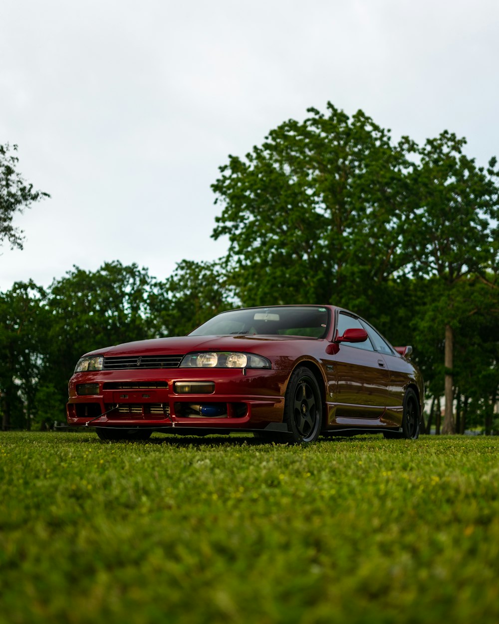 a red car parked on grass