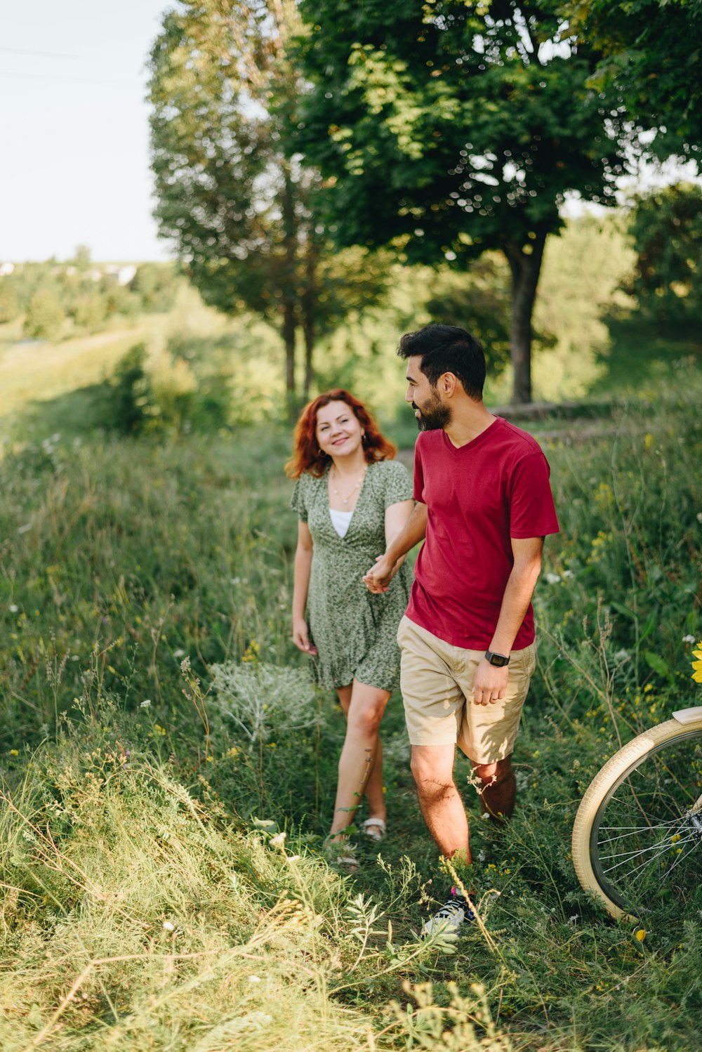 a man and woman walking in a field