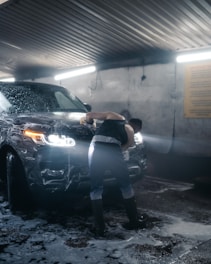 a person leaning against a car