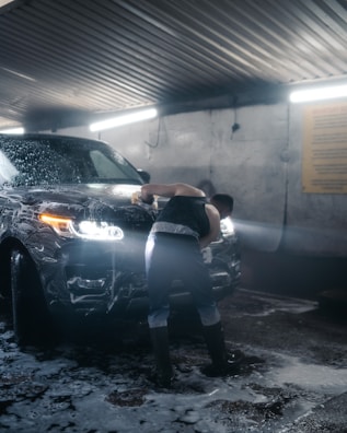 a person leaning against a car
