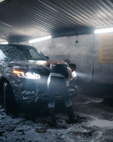 a person leaning against a car