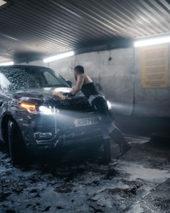 a man leaning on a car