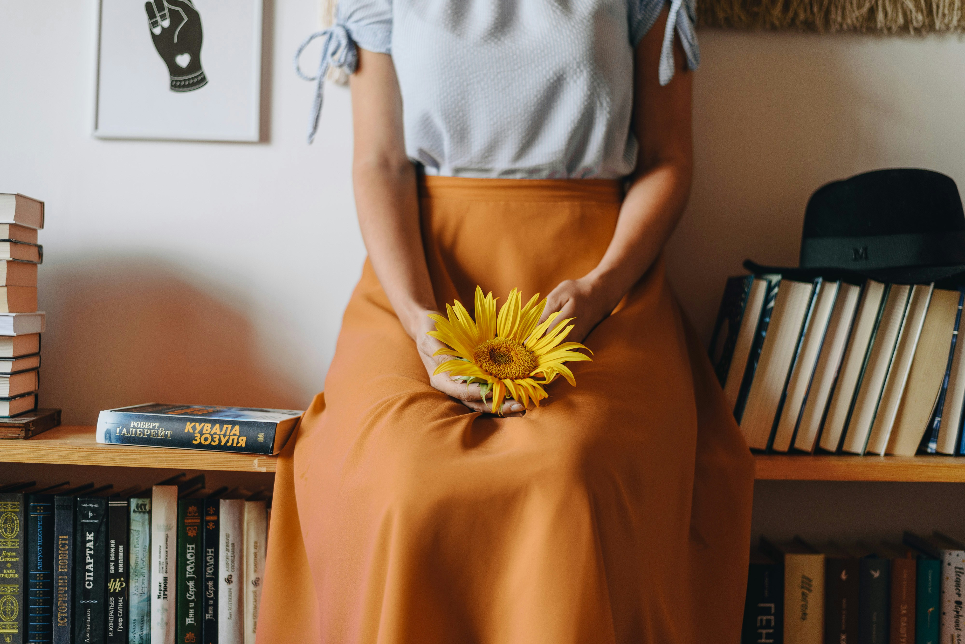 a person holding a yellow flower