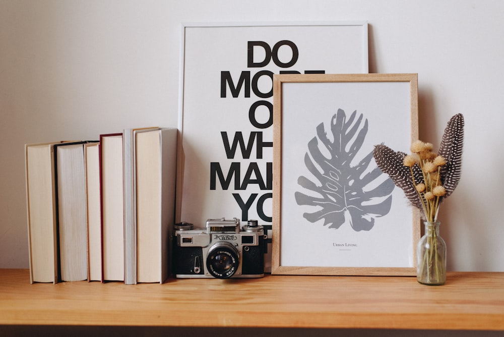 a vase of flowers and a camera on a table