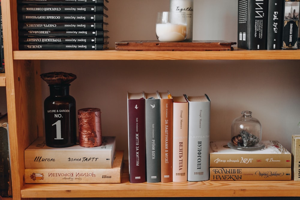 a shelf with books and containers on it