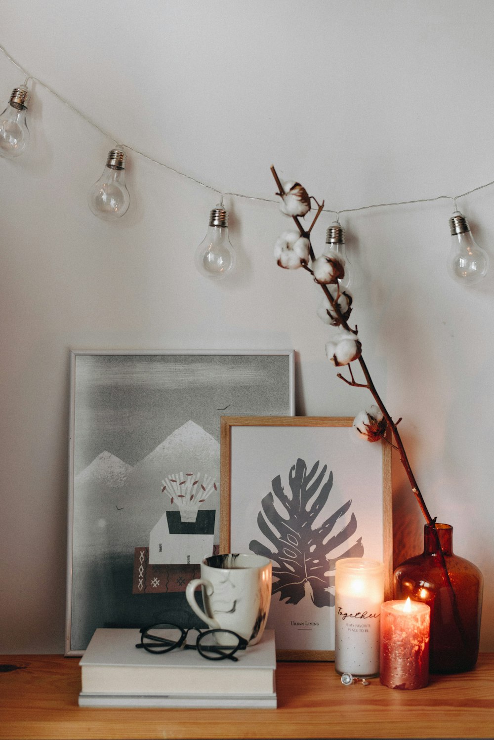 a picture frame and candles on a table