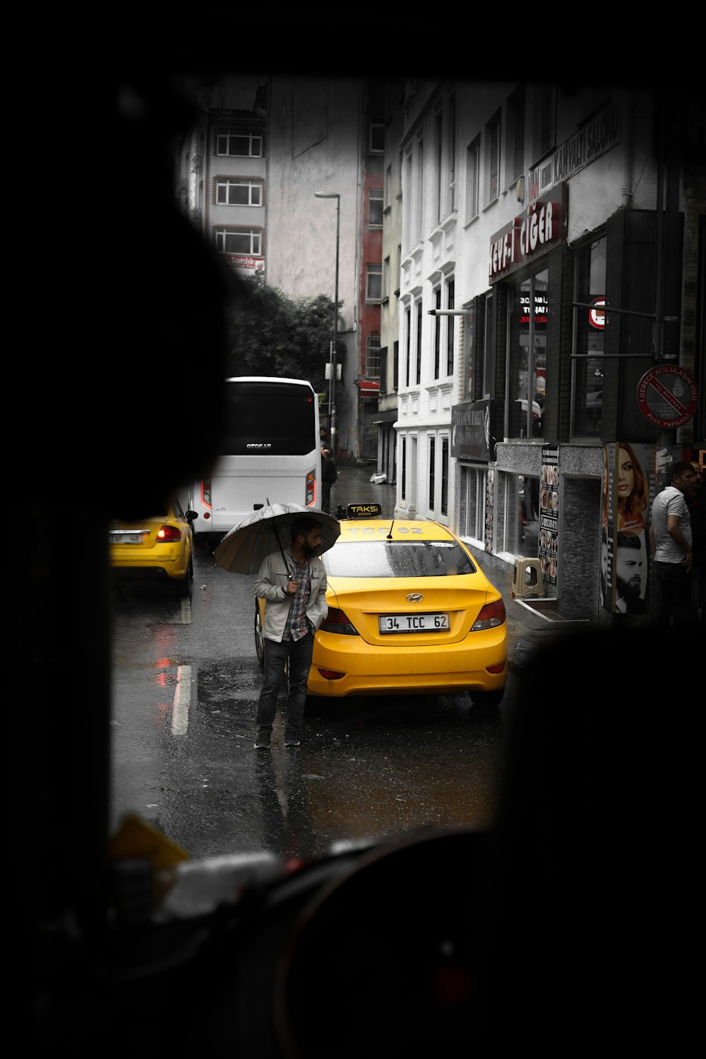 a person walking down a sidewalk with an umbrella