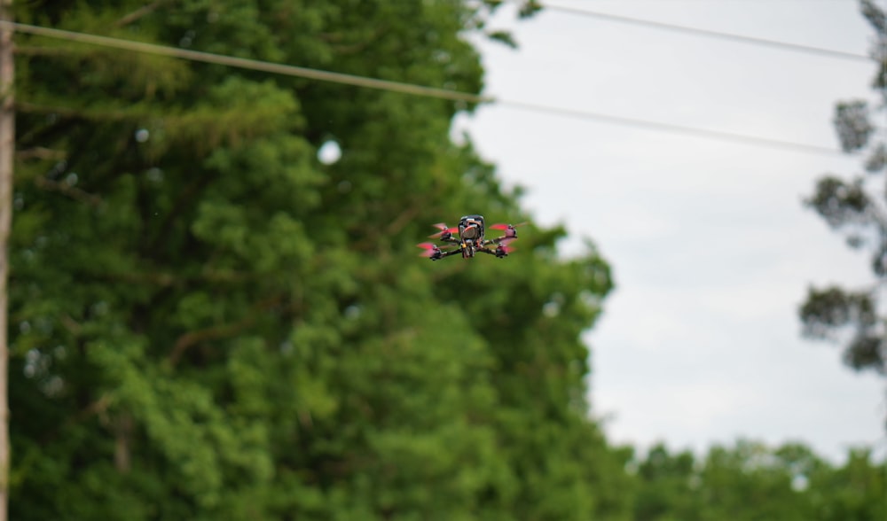 a group of red and white drone flying in the air