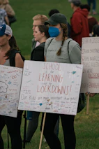 A vibrant school community event with banners supporting education rights.
