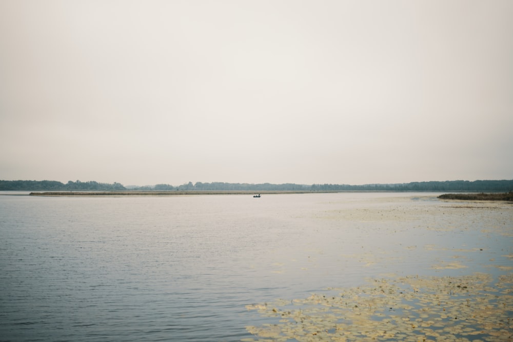 a body of water with land in the distance