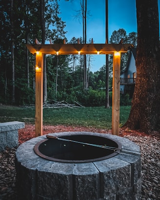 a round metal structure with a metal frame and a metal frame with trees in the background