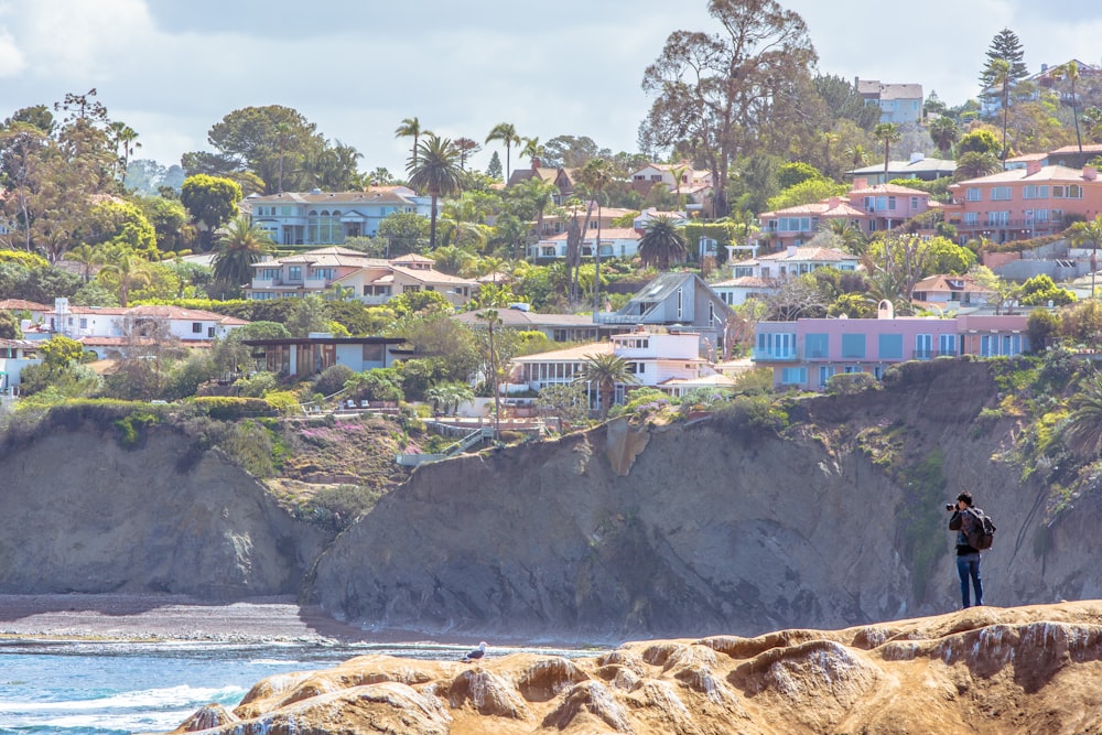 a person standing on a rock overlooking a town