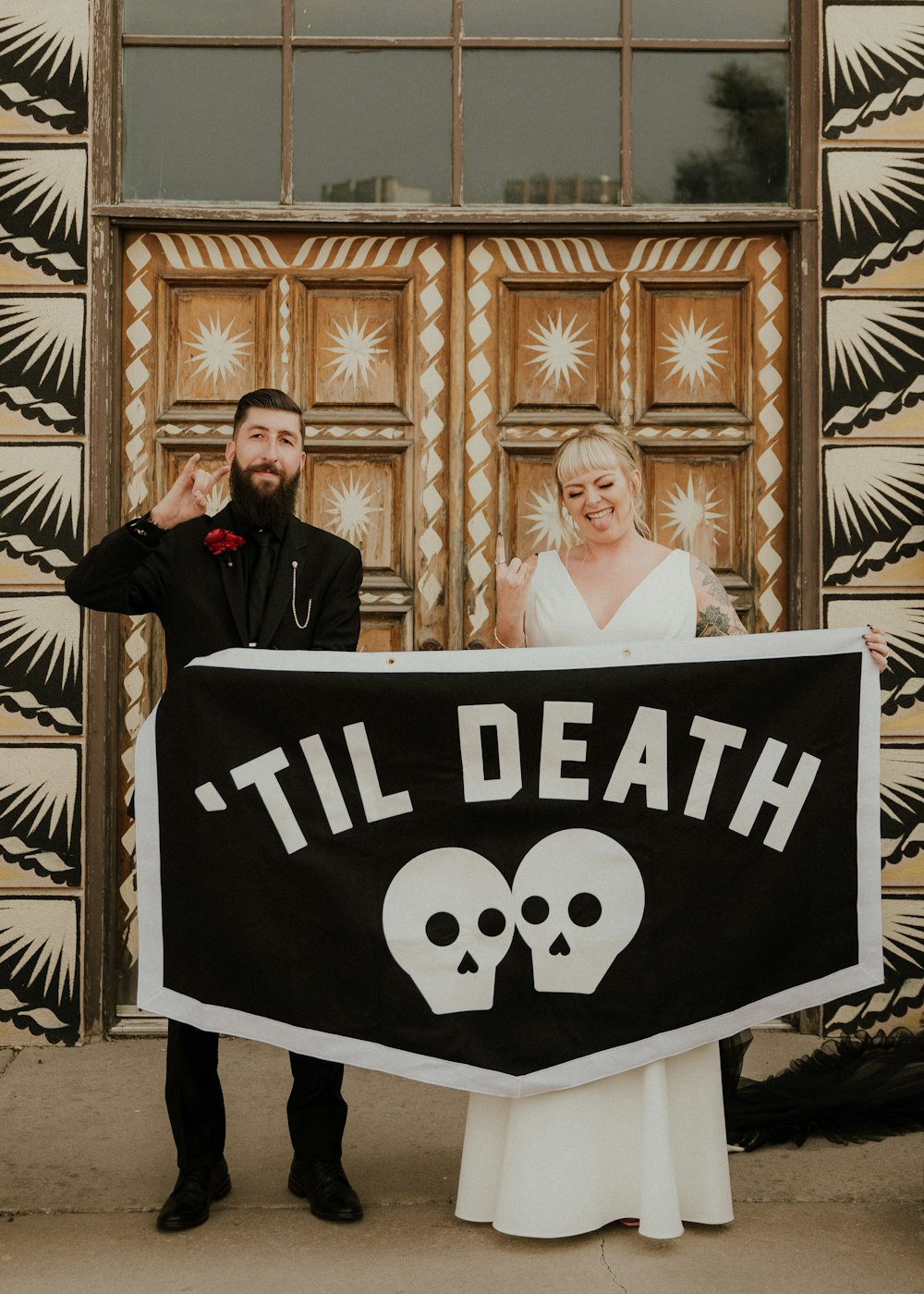 a man and woman holding a sign