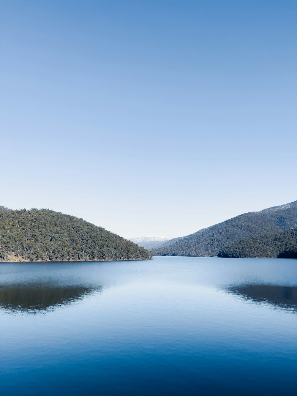 a body of water with hills in the background