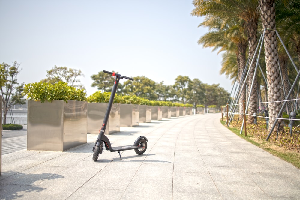 a stroller with a wheelbarrow on a sidewalk