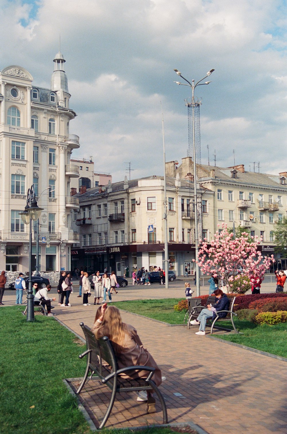 a group of people sitting on benches in a park