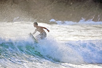 a man surfing on a wave