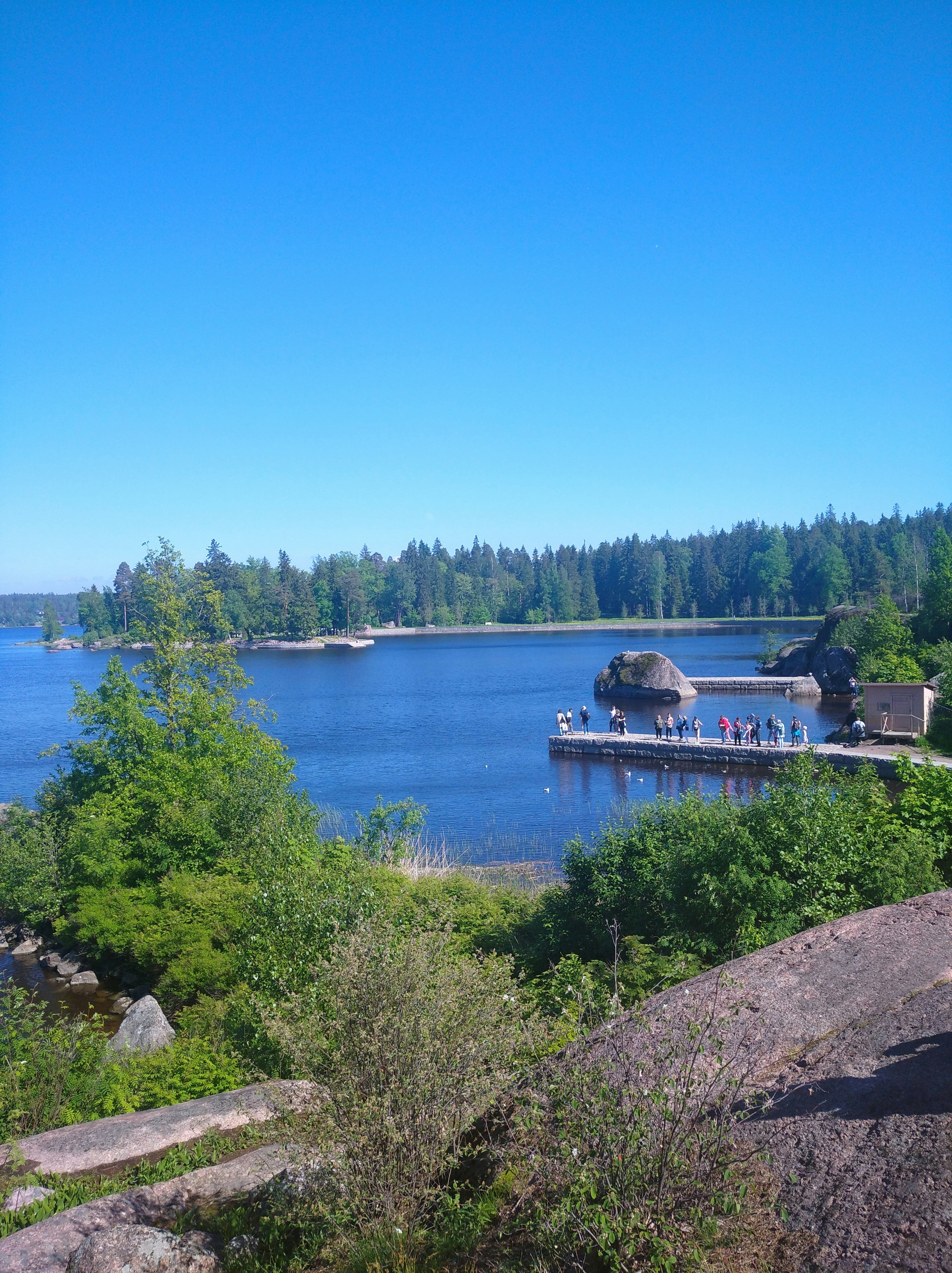 a building on a hill by a body of water