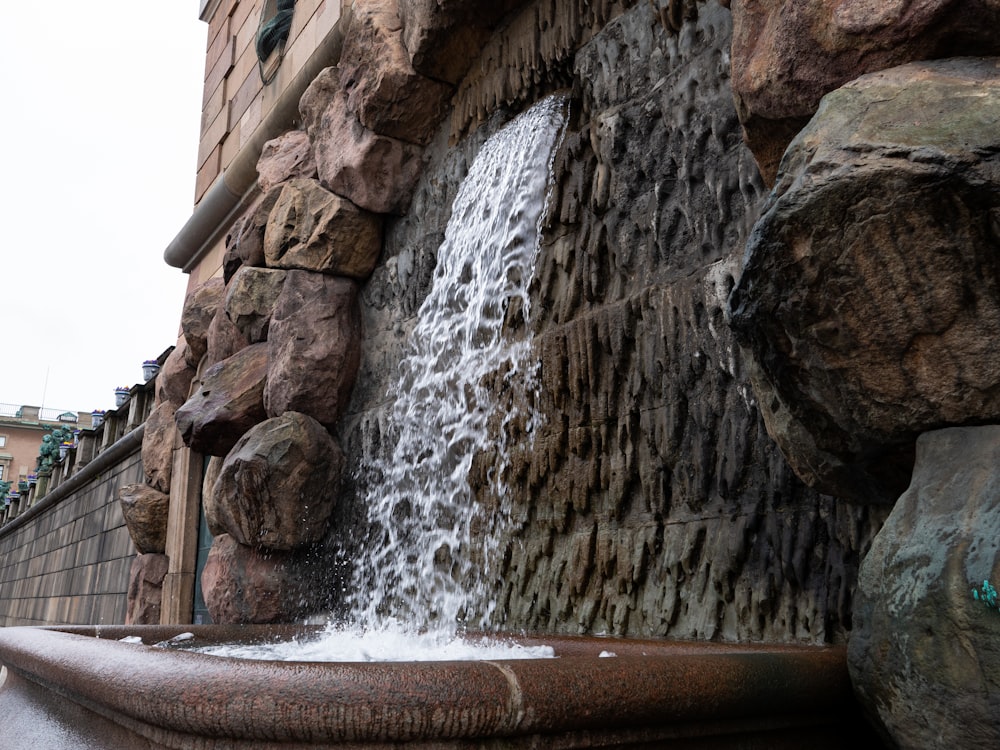 a waterfall over a rock wall