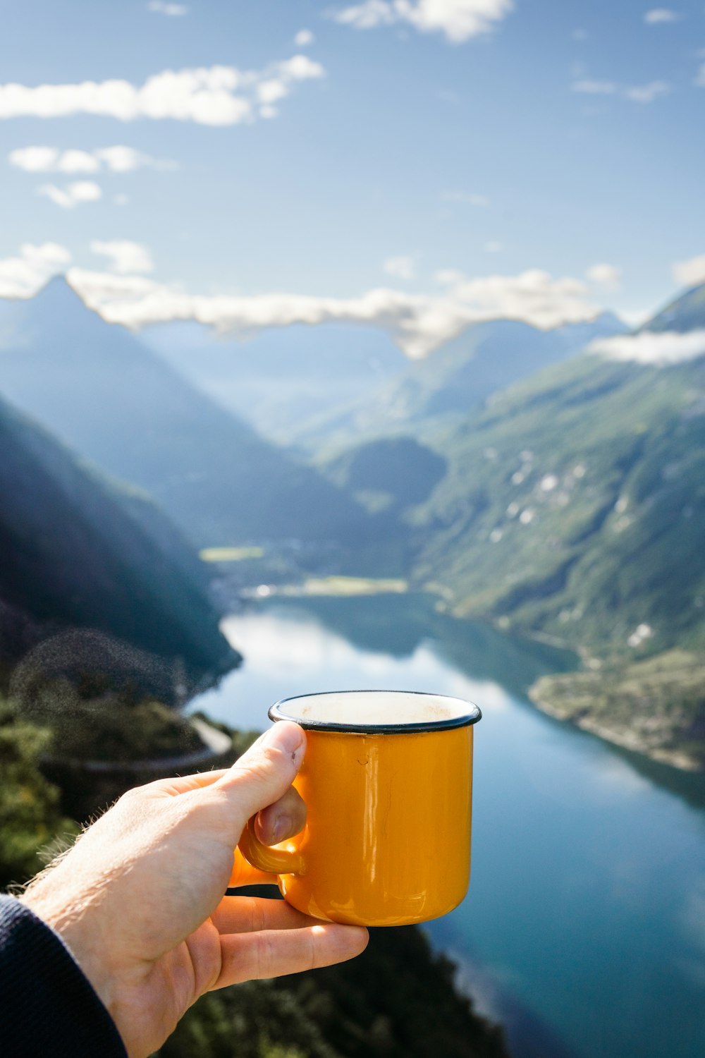 a hand holding a glass of beer