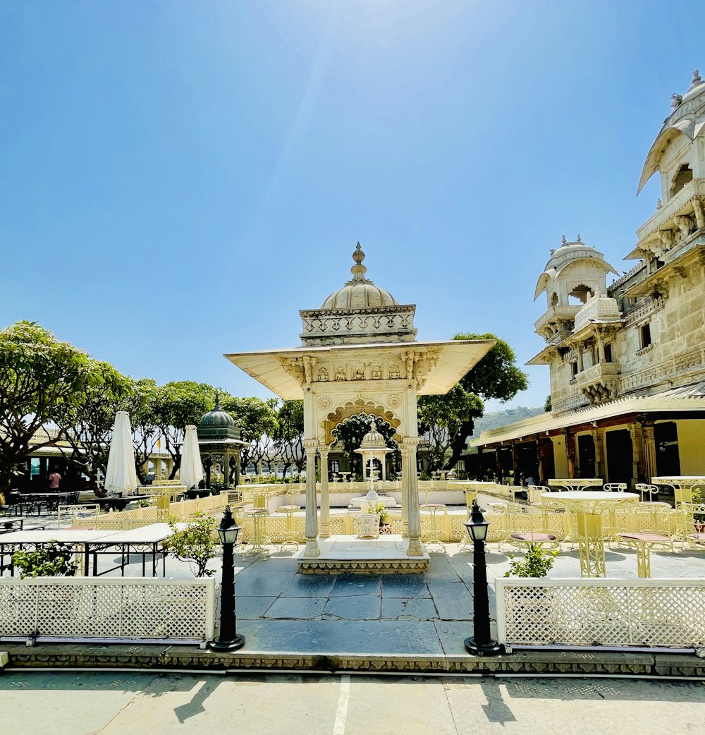 a large ornate building with a gold gate and a fountain in front