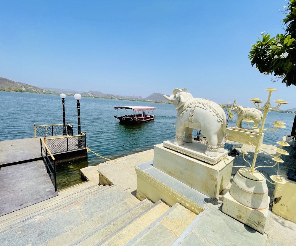 a white statue on a dock