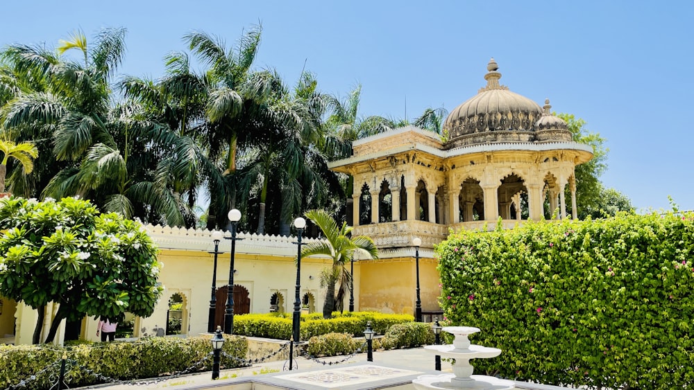 a building with a dome and palm trees