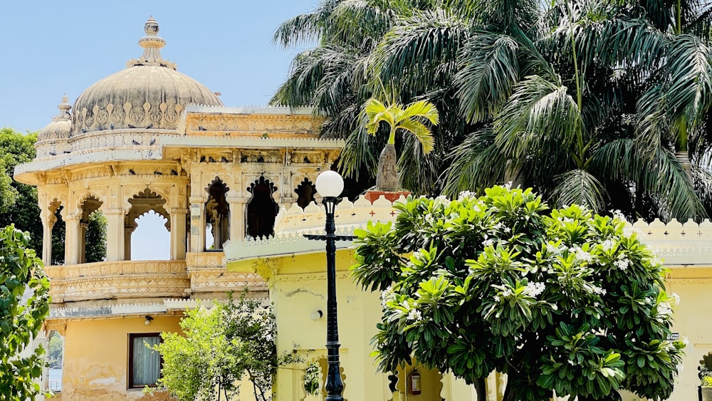 a building with a domed roof and palm trees