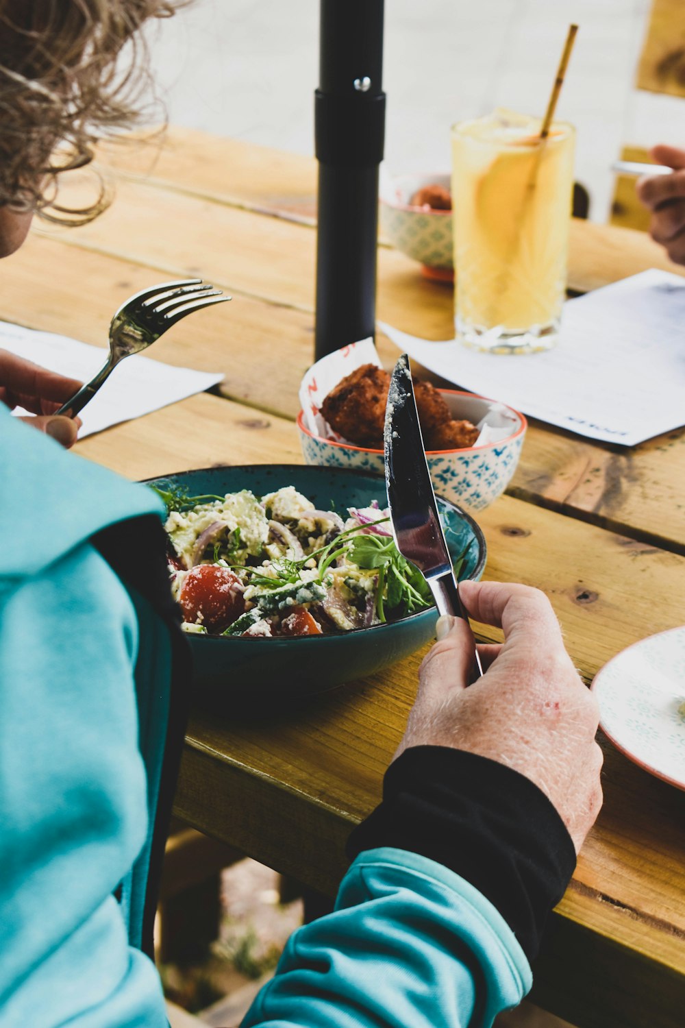 a person holding a knife and fork