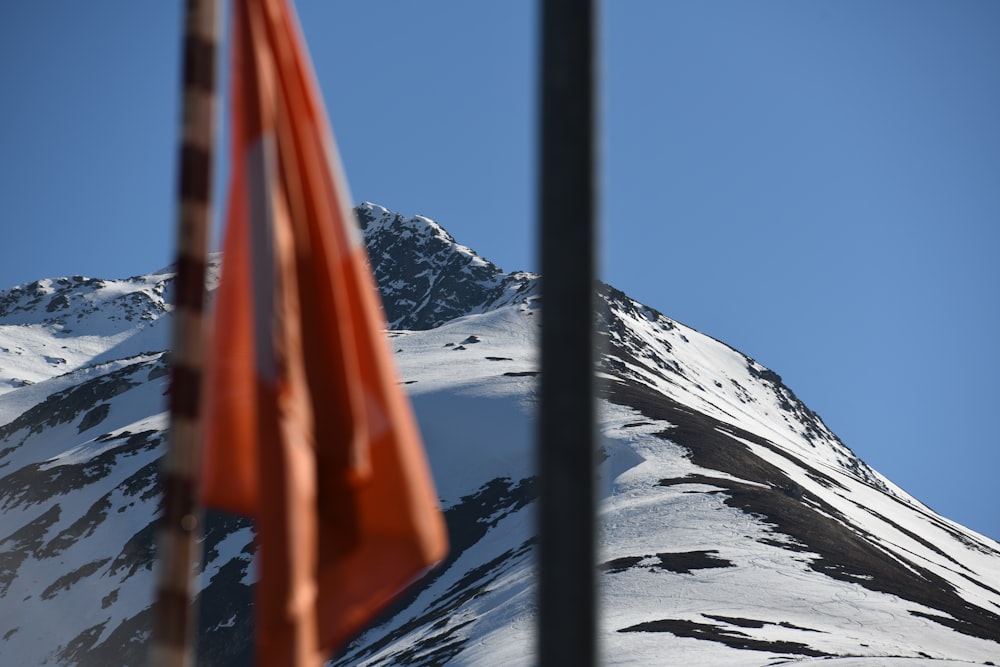 a red metal gate on a snowy mountain