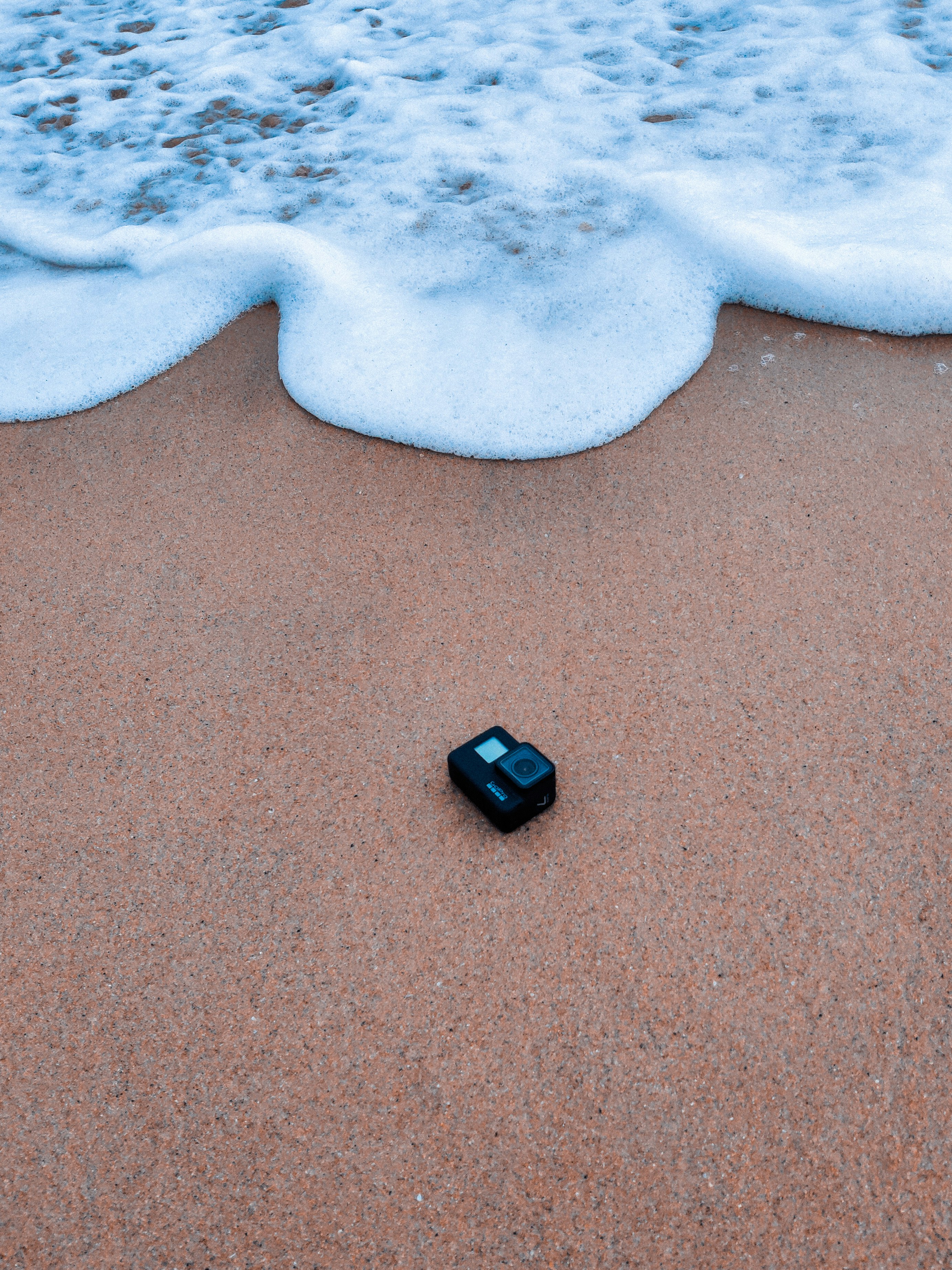 a small black device on a beach