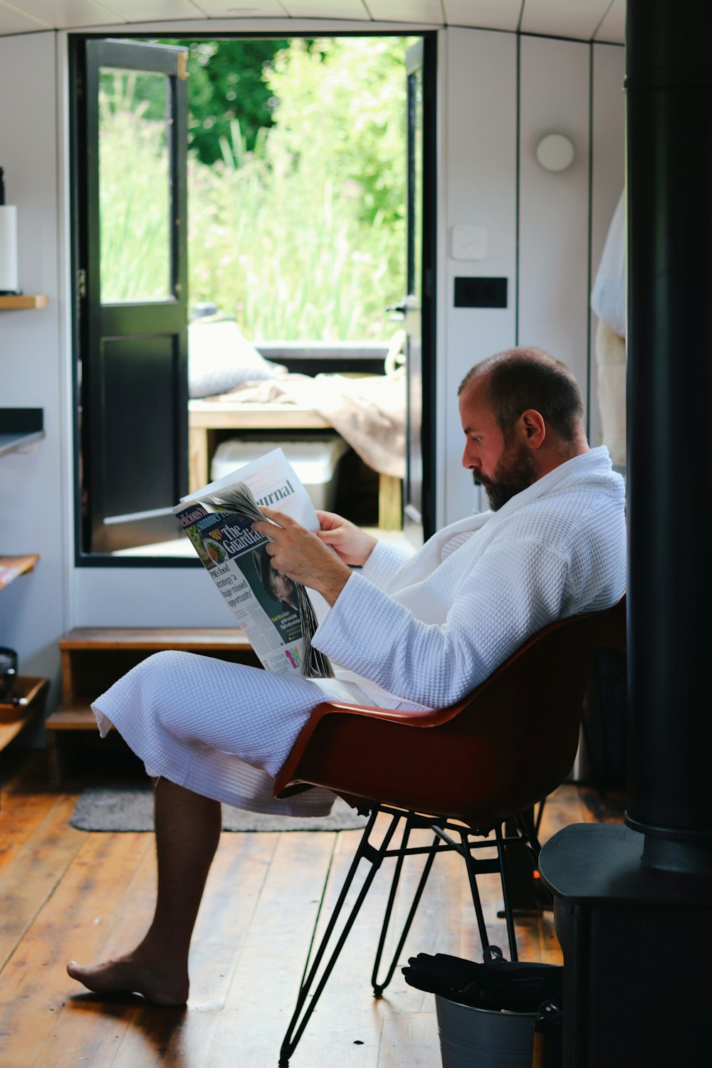 a person sitting in a chair reading a book