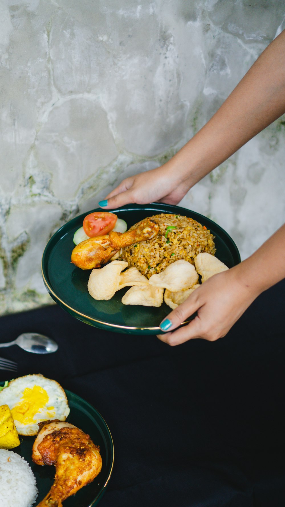 a person holding a plate of food