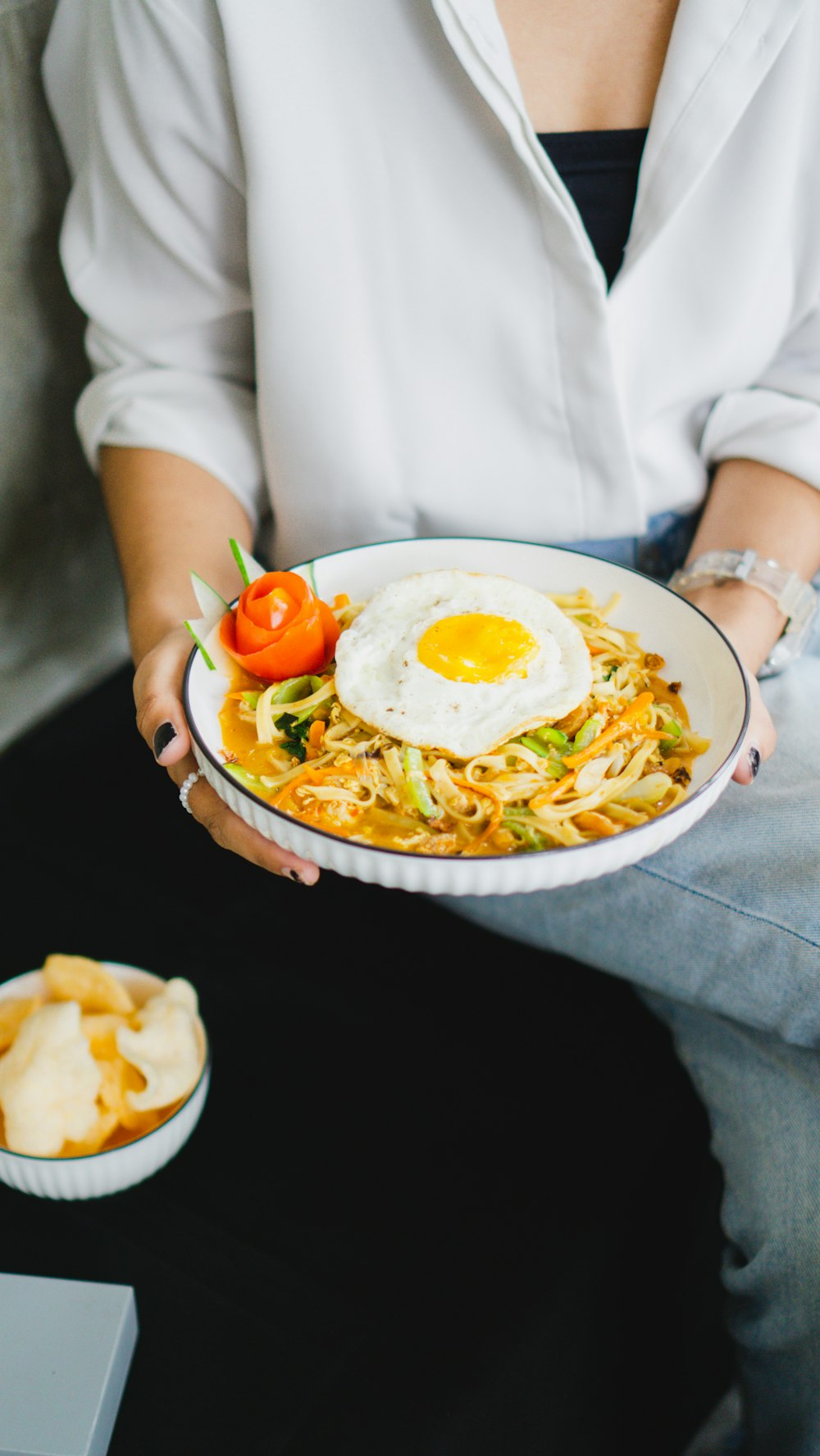 a person holding a plate of food