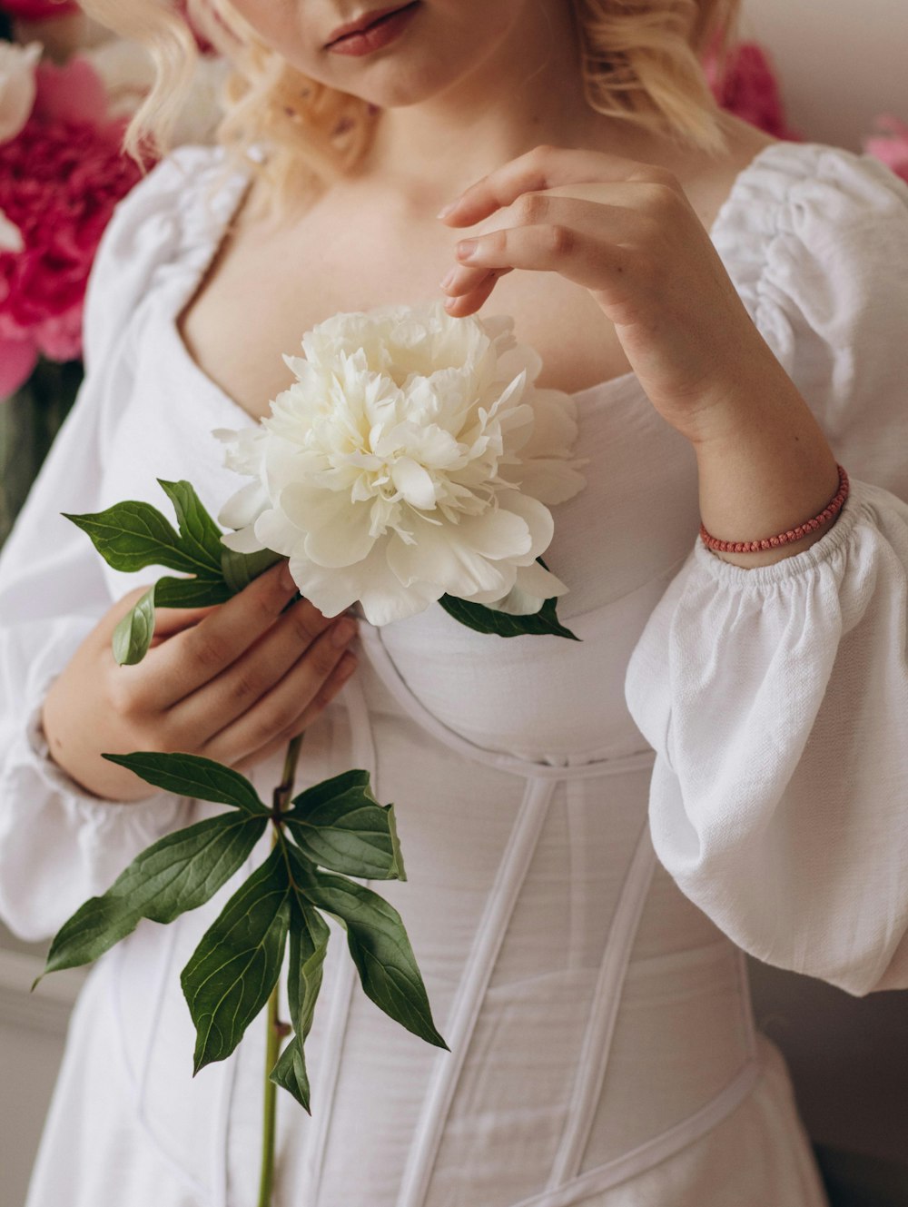 a person holding a white flower