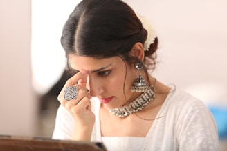 a woman with her hand on her face