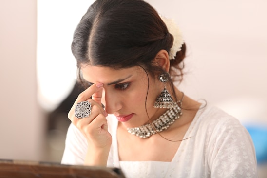 a woman with her hand on her face