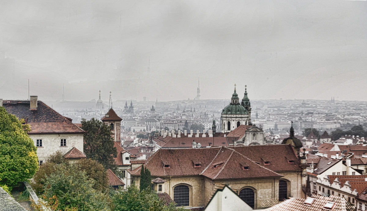 Prague red rooftops, church spires, and the curving Vltava River seen from Letná Park viewpoint