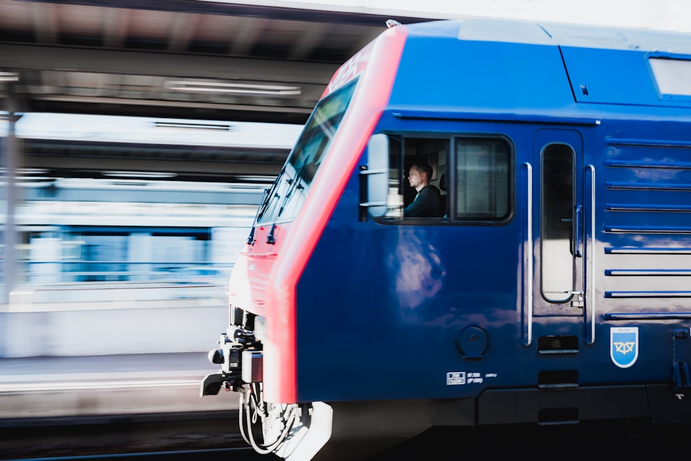 a person sitting in a blue train