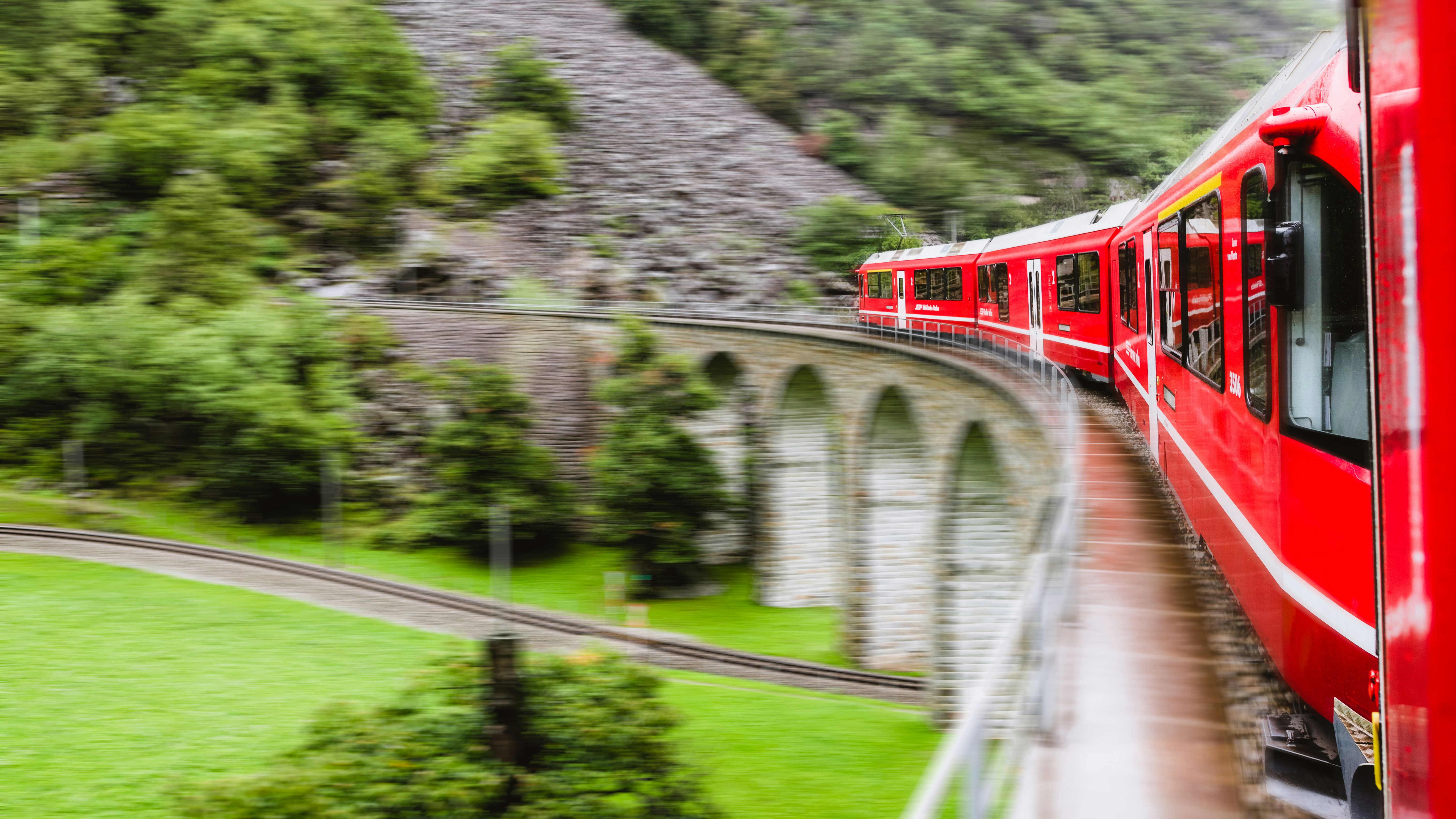 A regional train of RhB heading over the Brusio Viaduct