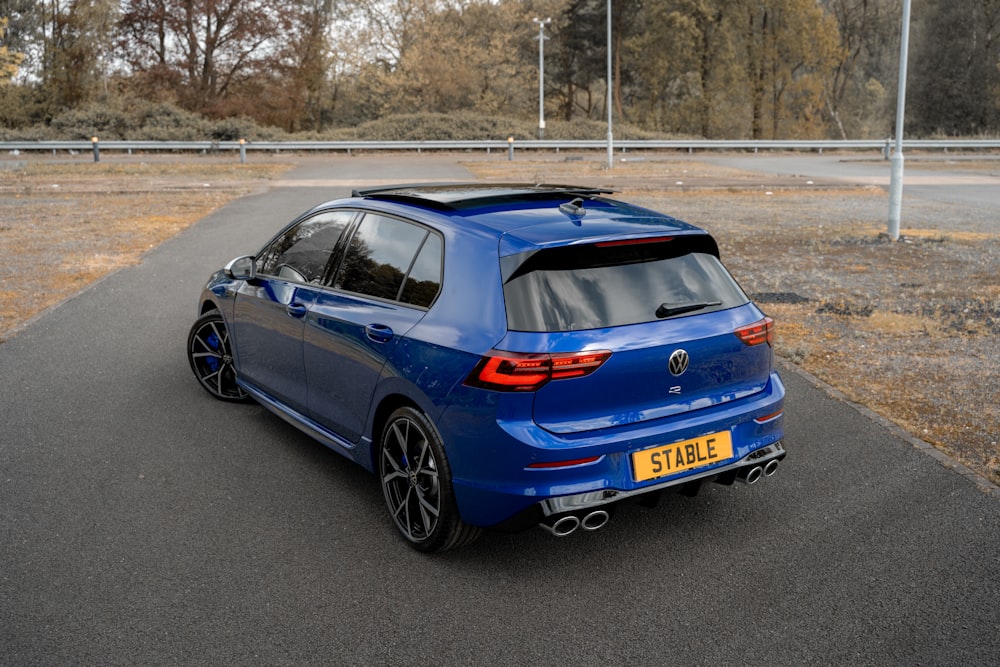 a blue car on a road