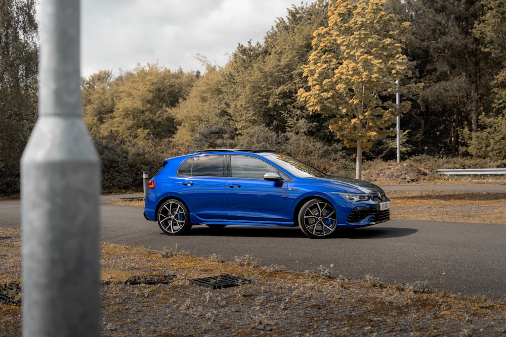 a blue car parked on a road