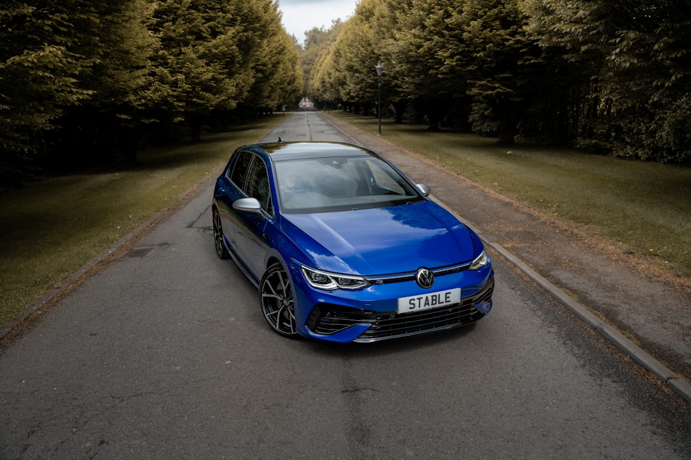 a blue car on a road