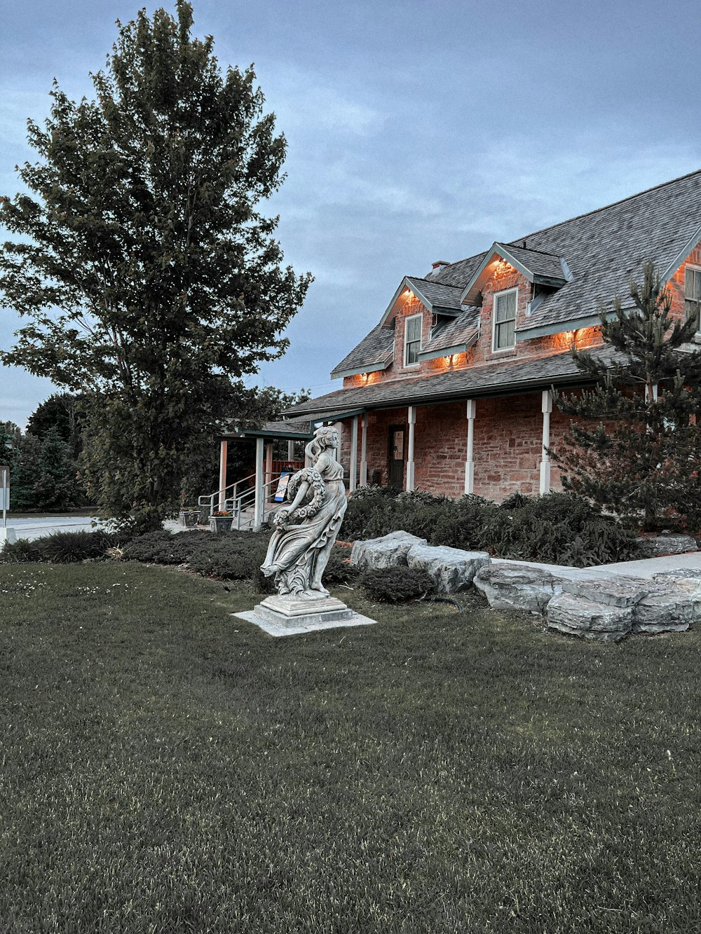 a statue in front of a house