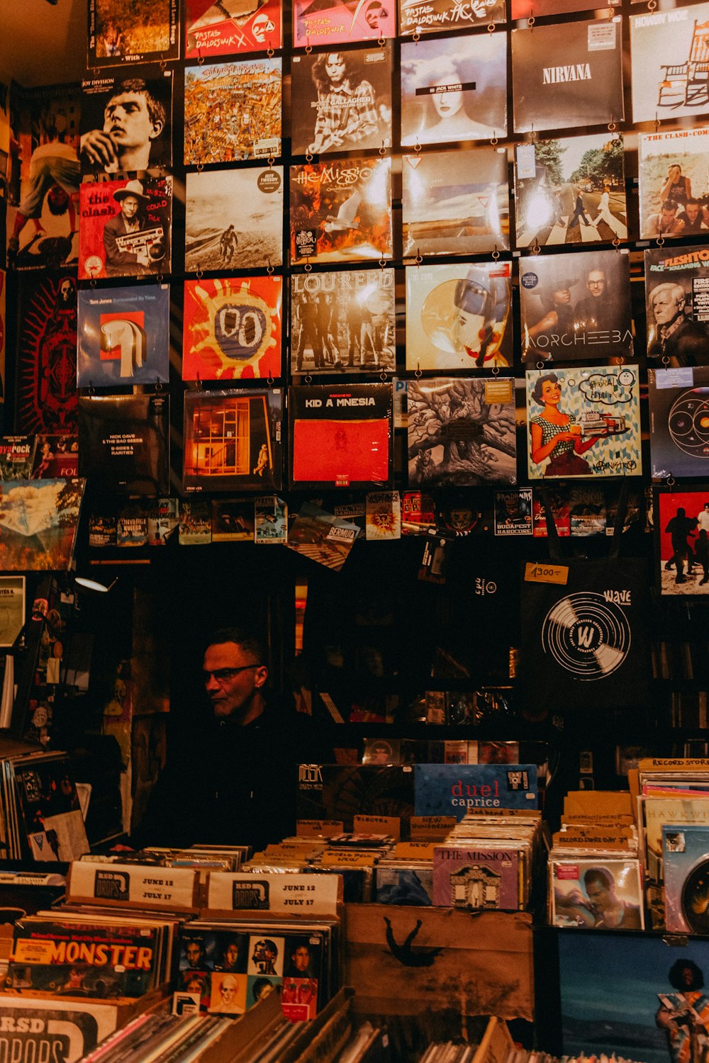 a person standing behind a wall of video games