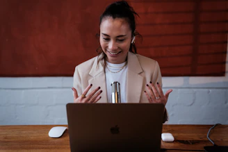 A confident woman entrepreneur reviewing her brand voice notes on a laptop.